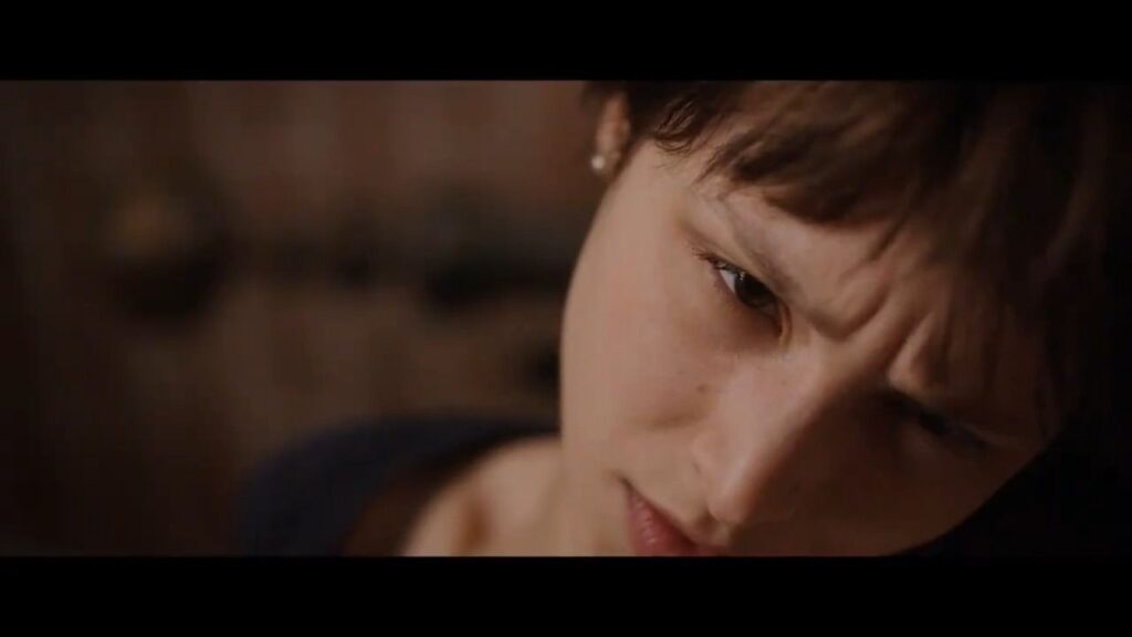 A close-up of a distressed young woman looking downwards in the Christmas Eve thriller Body.