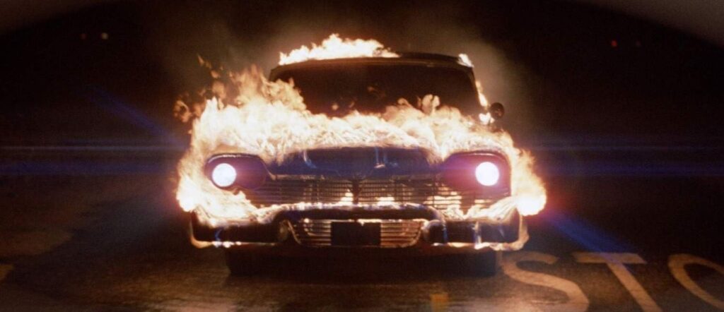 The haunted red and white 1958 Plymouth Fury from John Carpenter's Christine (1983), an iconic horror movie car based on the Stephen King novel.